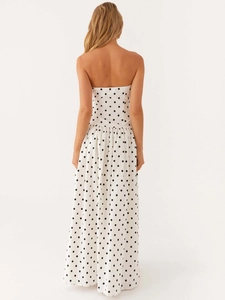 Bohemian strapless maxi dress in cream white with black polka dots shown from the back view