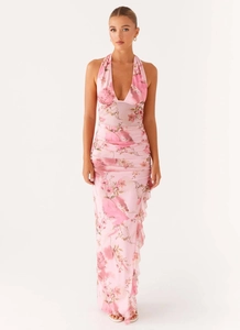 Detail of pink floral halter maxi dress with deep V-neck and ruffled hemline