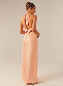 Detailed back view of peach satin maxi dress with halter neck and open back tie design