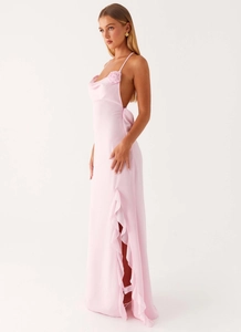 Detail of pink satin dress with 3D flower, open back, and ruffled side slit detail