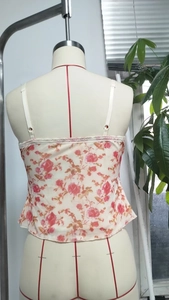 Rear view of floral camisole on mannequin with red roses and delicate lace trim