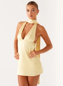 Detail of light yellow satin mini dress featuring deep V-neck and long elegant neck ties