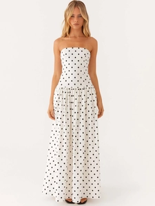 Elegant strapless white maxi dress with black polka dots and a flared A-line silhouette