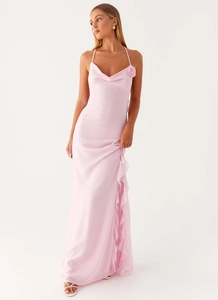 Detail of pink satin dress featuring a 3D floral accent and elegant side slit ruffle