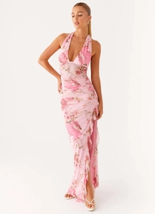 Detail of pink floral halter dress showing ruffled hemline and high slit design
