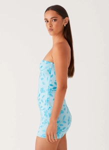 Detail view of light blue sequin embroidery and floral beading on a strapless mini dress