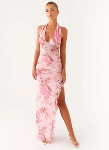 Detail view of pink floral halter maxi dress with ruffle hem and side slit design