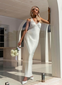 Detailed view of white halter neck satin gown with deep V-neck and pleated chest design