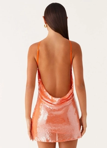 Detail of the bright orange sequin mini dress featuring a cowl back and thin straps