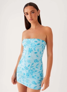 Detail of light blue bodycon dress featuring intricate floral sequins and beadwork