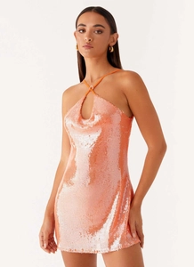 Close-up of coral sequin halter mini dress with teardrop cutout and cowl neckline