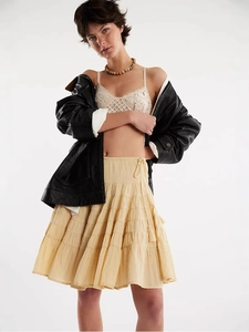 Chic cream tiered mini skirt paired with lace vest and black leather jacket for women