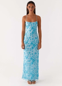 Detail of light blue halter dress featuring intricate navy floral embroidery and beadwork