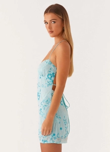 Detail of light blue mini dress featuring intricate beadwork and floral embroidery