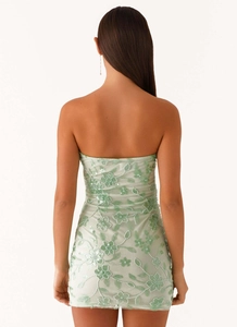 Detailed back view of a light green strapless mini dress with floral sequin embroidery