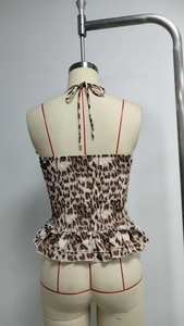 Detail view of leopard print tube top featuring smocked fabric and ruffled hemline