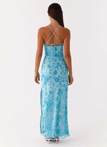 Close-up of blue floral embroidery on light mesh fabric of a backless maxi dress