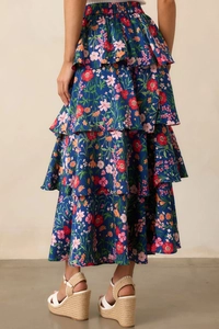 Detail view of tiered ruffles and floral print on navy blue summer maxi skirt