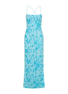 Detail showing blue sequin floral embroidery and cross back straps on a long dress