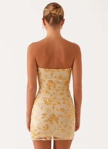 Detailed back view of a bodycon mini dress featuring floral embroidery and sequins