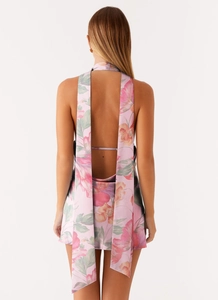 Detail of elegant backless dress with pink floral pattern and long neck ties