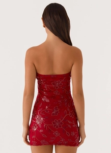 Detail of red sequin floral embroidery on a backless bodycon strapless mini dress
