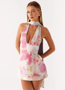Detailed view of pink floral print and halter deep V-neck on a mini summer dress