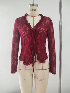Detailed view of dark red sheer lace cardigan featuring ruffle trim and front tie closure