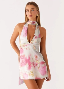 Detailed view of the deep V-neckline and floral print on satin halter mini dress