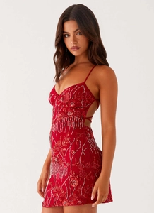 Detail of red sequined dress showing delicate beadwork and open back with lacing