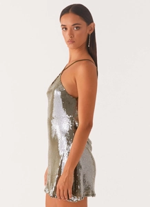 Detailed view of shimmering olive green and silver sequins on a mini party dress