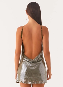 Detail view of sparkly silver sequins on a backless mini dress with thin straps