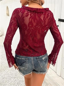 Close-up back view of burgundy sheer lace crop top with floral patterns and ruffled edges