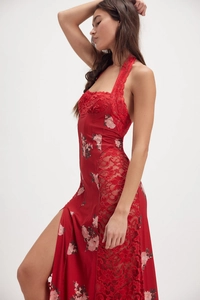 Detail of red halter dress with lace patchwork, floral print, and a high side slit