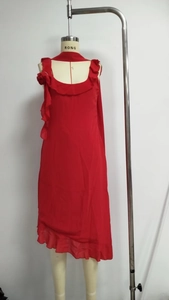 Detail of red chiffon sleeveless dress featuring ruffled neckline and floral shoulder design