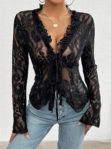 Close-up of black floral lace top with ruffled edges, V-neckline, and front tie detail