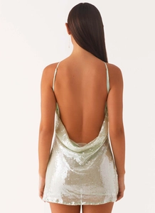 Macro shot of mint green sequin mini dress featuring a low back U-shape draped design