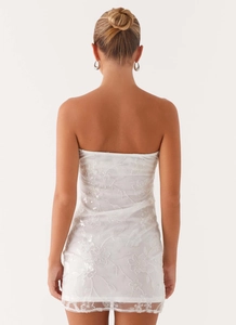 Detailed back view of white strapless mini dress with floral sequin embroidery and mesh