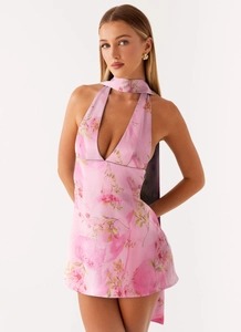 Detail of pink floral halter dress featuring deep V-neckline and matching silk-feel neck scarf