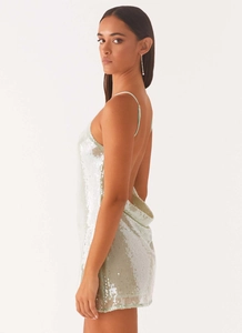 Detail of silver sequin mini dress featuring thin straps and an open back design