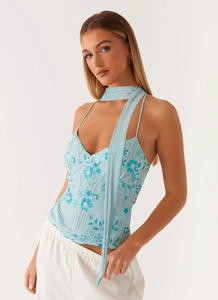 Detail of light blue sequined tank top with floral embroidery and matching neck scarf