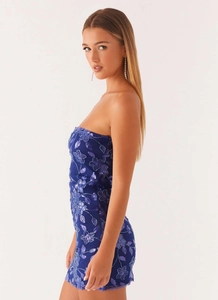 Detail of dark blue bodycon dress with purple floral embroidery and shiny sequins