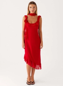 Detail of red chiffon dress featuring an asymmetrical ruffled hem and handmade 3D rose