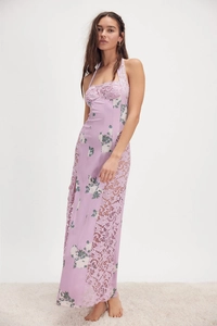 Detail of purple floral long dress featuring lace patchwork and halter neck design