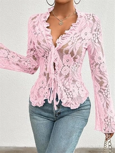 Detail of pink floral lace top featuring V-neckline, ruffles, and front tie closure