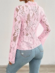 Detail of pink floral lace top featuring a high neck and ruffled cuffs on model back