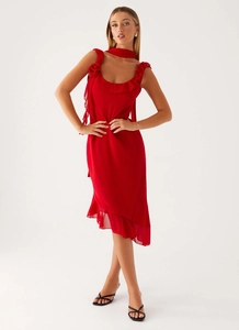 Detail of red chiffon dress featuring ruffled hem and elegant floral shoulder accents