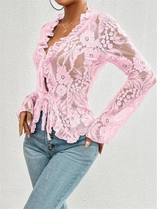 Detail of pink floral lace texture with ruffle trim and front tie closure on cropped top