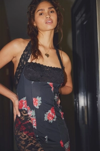 Detail of halter neck dress featuring black lace trim and vintage floral mesh print