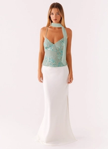 Detailed view of the beaded sequin top and satin maxi skirt with high side slit set
